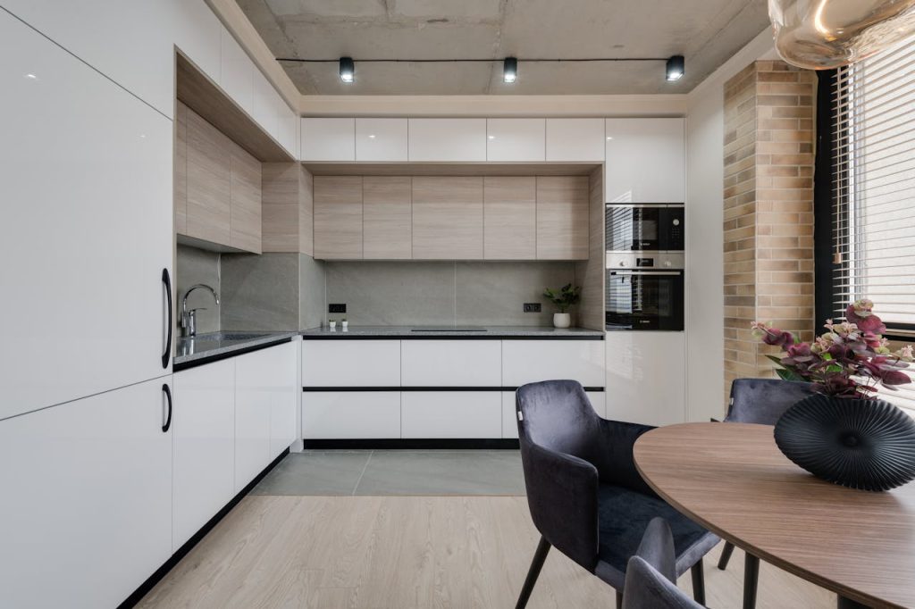 Spacious modern kitchen interior with dining area and elegant design elements.